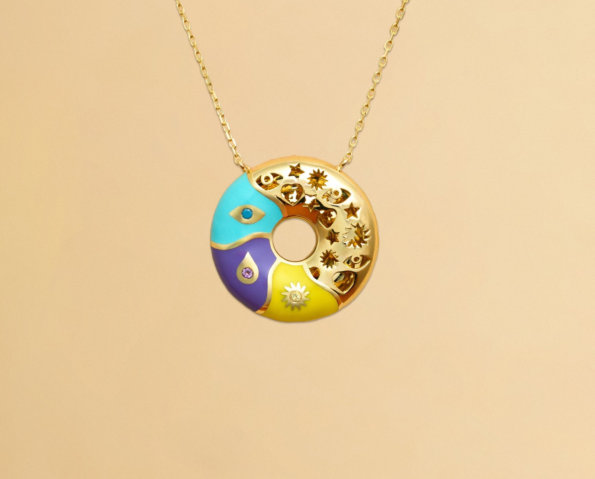 Six 18K gold baby bracelets with colored enamel bars and gold symbols on a blush-pink background.